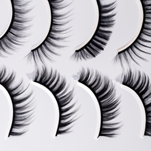 Close-up of a variety of fake eyelashes in different lengths arranged in a semi-circle.