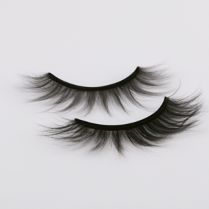 A close-up of a pair of faux mink eyelashes on a white background.